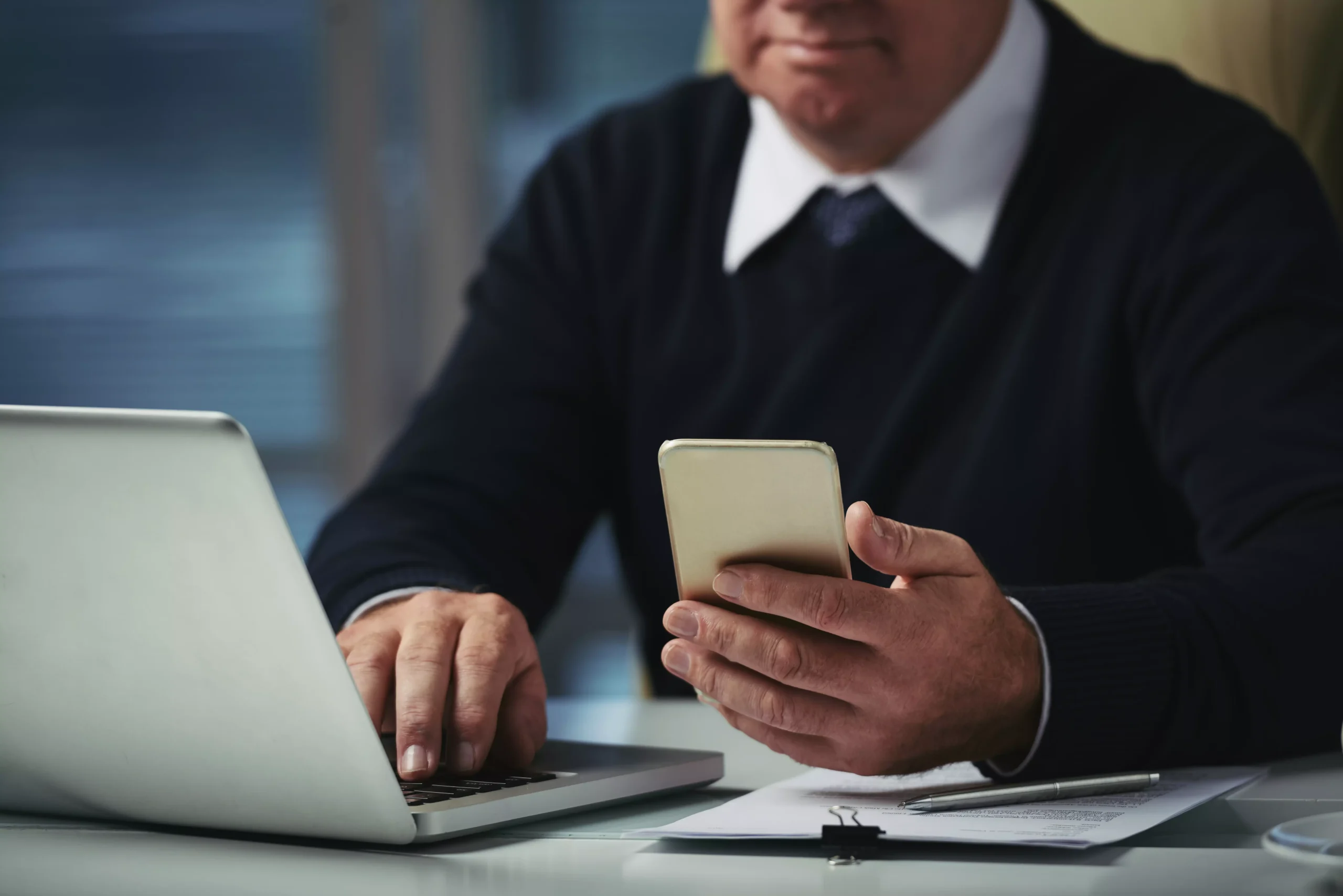 cropped man checking messages his phone office scaled.webp